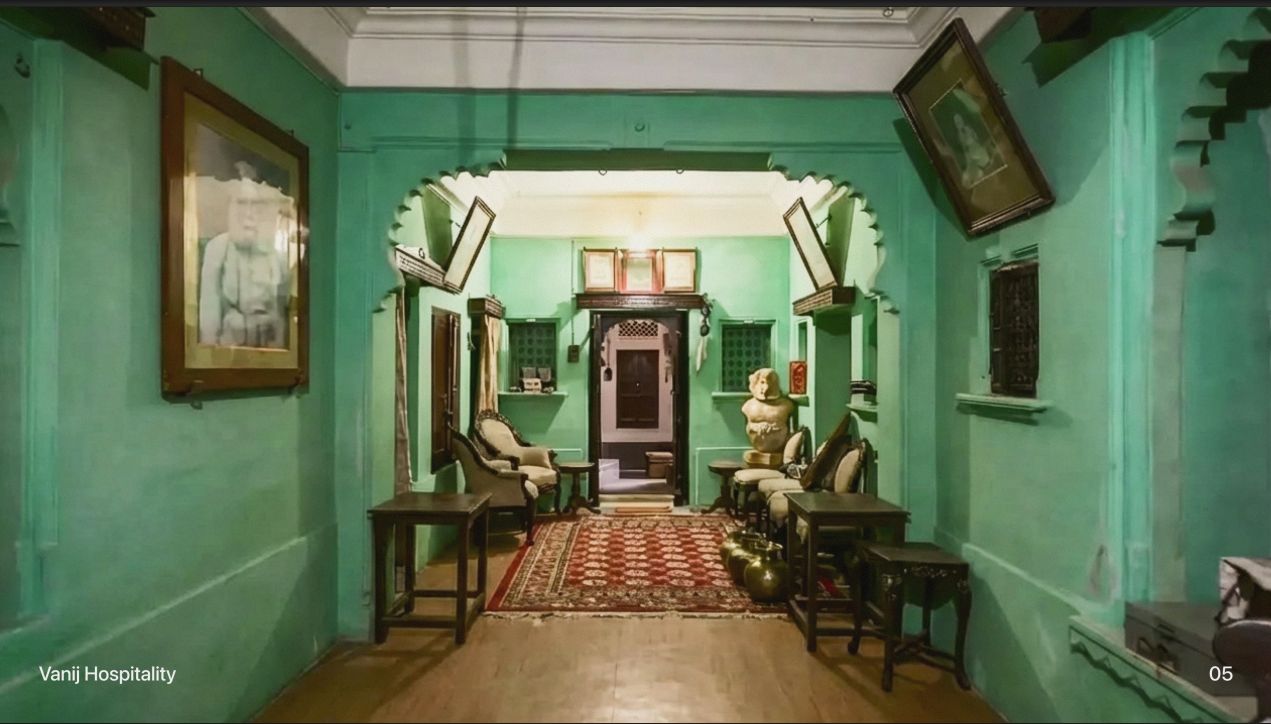 The foyer, hung with portraits and lit by lantern light